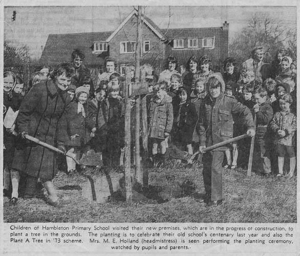 Planting a tree at the site of the 'new school'.