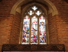 The oak carving by G W Milburn above the altar